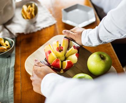 Ein frischer Südtiroler Apfel wird in kleine Stücke geschnitten, um verkostet zu werden.